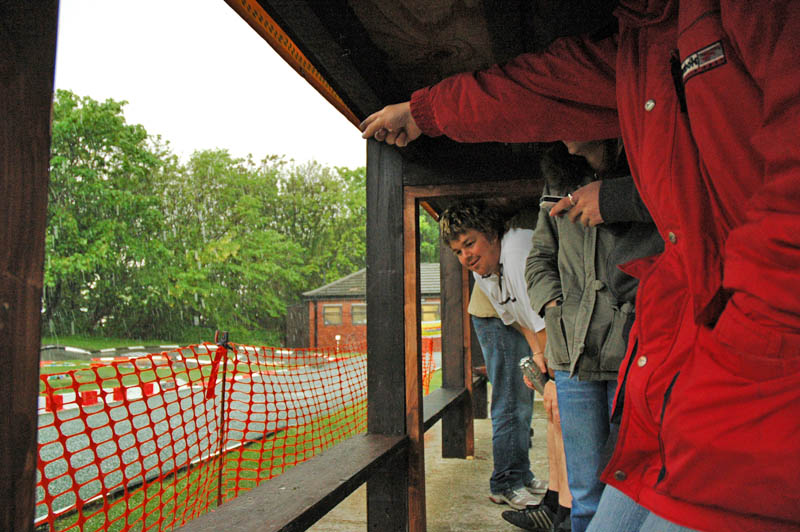 a few of us take shelter under the rostrum in the storm