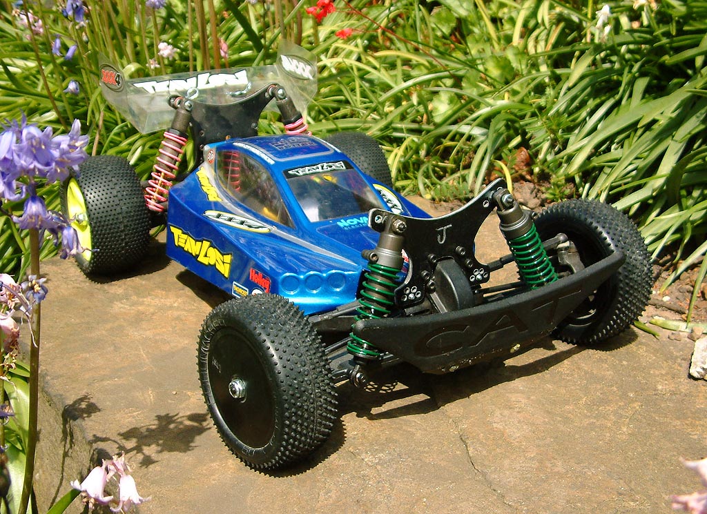My xxx4, before this first race.. Made me own shock towers, front is padded with o rings to cussion it a bit.. and a big C.A.T. Bumper!  yay.. 